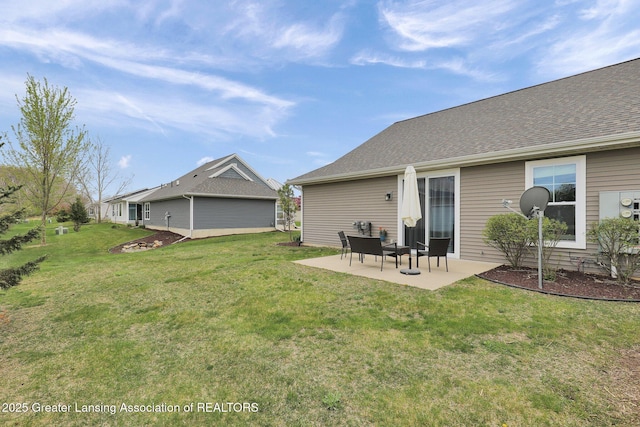 rear view of house with a yard and a patio