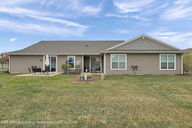 rear view of property with a yard and a patio area