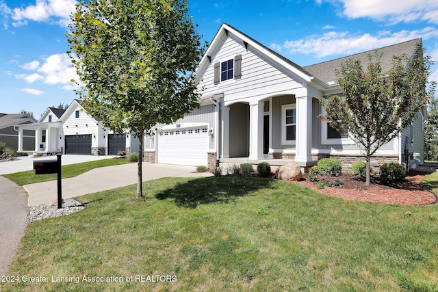 view of front of house featuring a garage and a front lawn