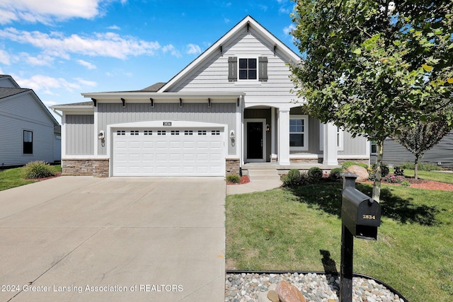 view of front of house featuring a garage and a front lawn