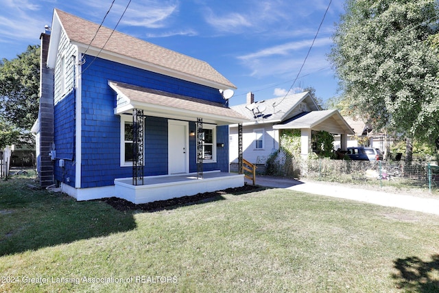 bungalow-style home featuring covered porch and a front lawn