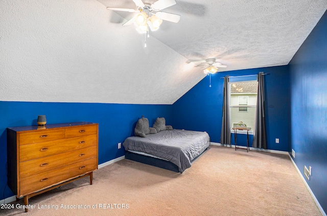 carpeted bedroom featuring ceiling fan, a textured ceiling, and vaulted ceiling