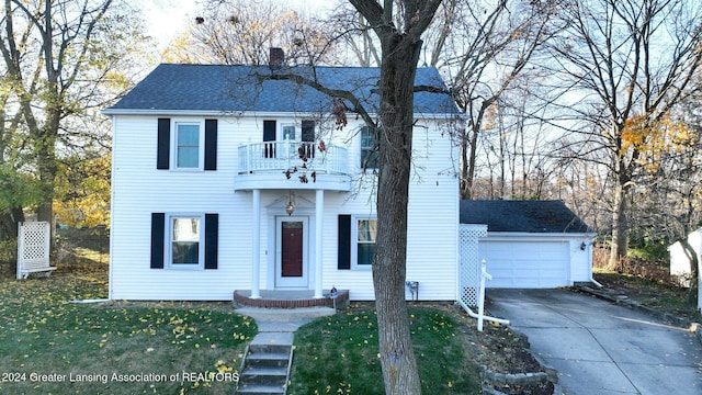 view of front facade featuring a balcony and a garage