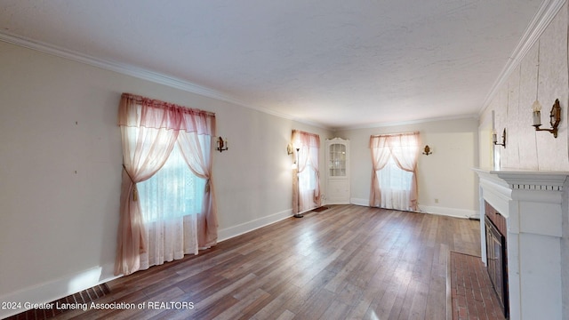 unfurnished living room featuring hardwood / wood-style floors and ornamental molding