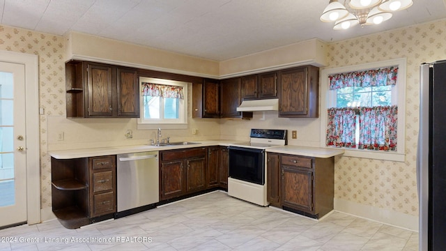 kitchen featuring plenty of natural light, sink, dark brown cabinets, and stainless steel appliances