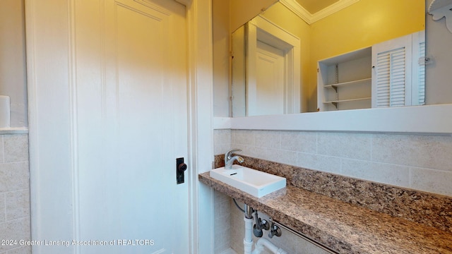 bathroom featuring crown molding and sink