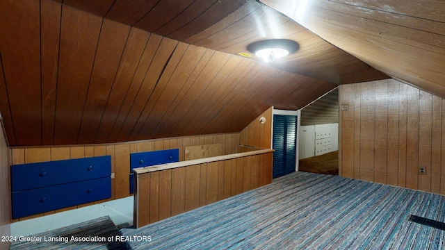 additional living space featuring carpet flooring, vaulted ceiling, wooden ceiling, and wood walls