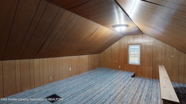 bonus room with carpet flooring, wood ceiling, wooden walls, and vaulted ceiling