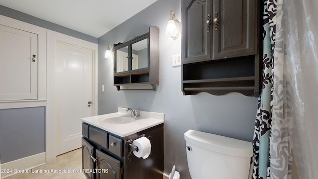 bathroom featuring vanity and toilet