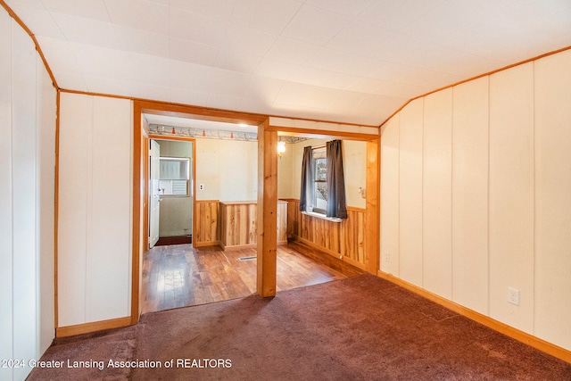 interior space featuring hardwood / wood-style floors and wooden walls