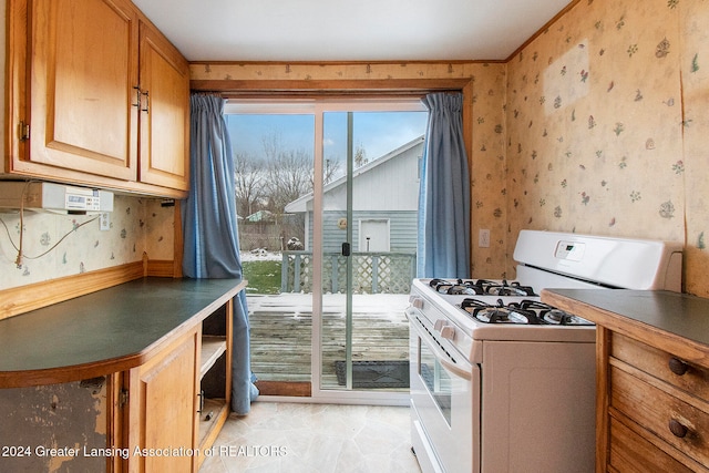 kitchen featuring white gas stove and light tile patterned flooring