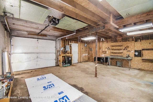 garage with a workshop area and a garage door opener