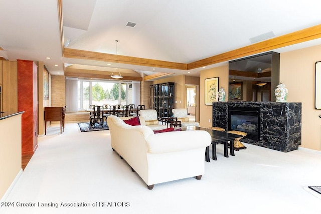 carpeted living room featuring a high end fireplace and lofted ceiling