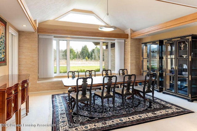 dining area featuring carpet floors and lofted ceiling