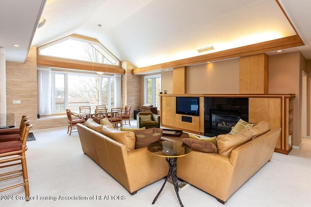 carpeted living room featuring lofted ceiling and a tiled fireplace