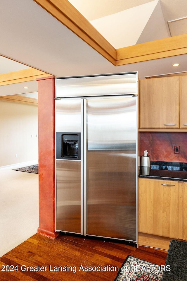 kitchen featuring light brown cabinets, dark hardwood / wood-style floors, and stainless steel built in refrigerator