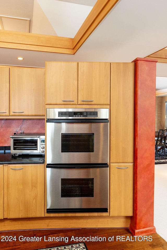 kitchen featuring double oven and light brown cabinets