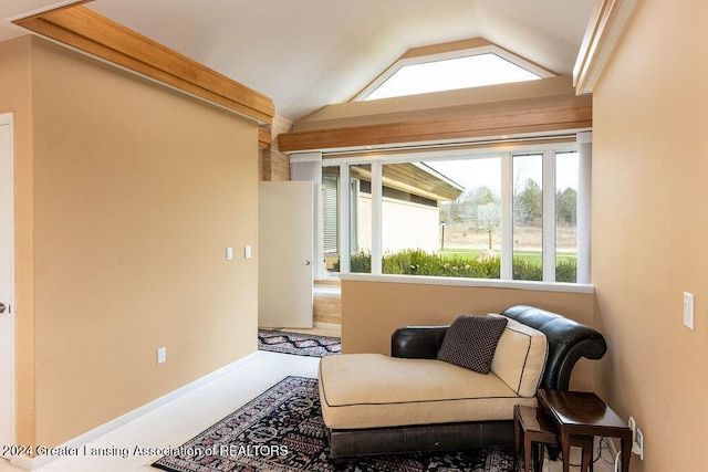 living area featuring carpet floors and vaulted ceiling