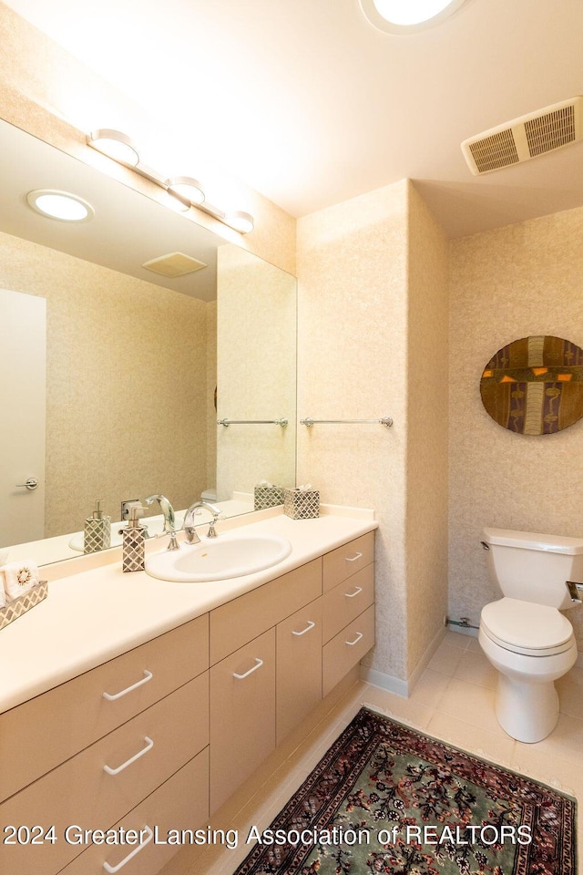 bathroom featuring tile patterned floors, vanity, and toilet