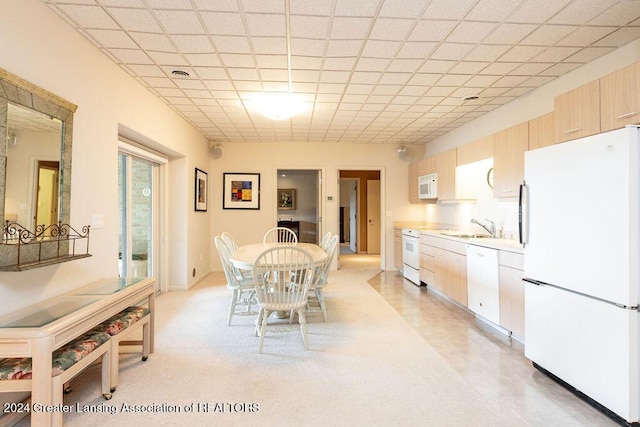 dining room with a paneled ceiling and sink