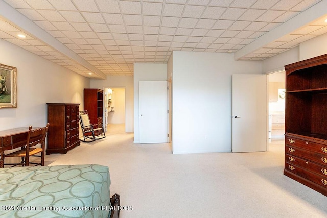 carpeted bedroom with a drop ceiling