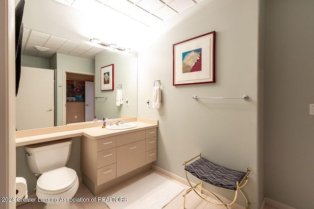 bathroom featuring tile patterned flooring, vanity, and toilet