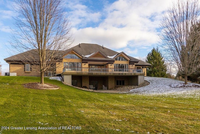 rear view of property featuring a wooden deck and a yard