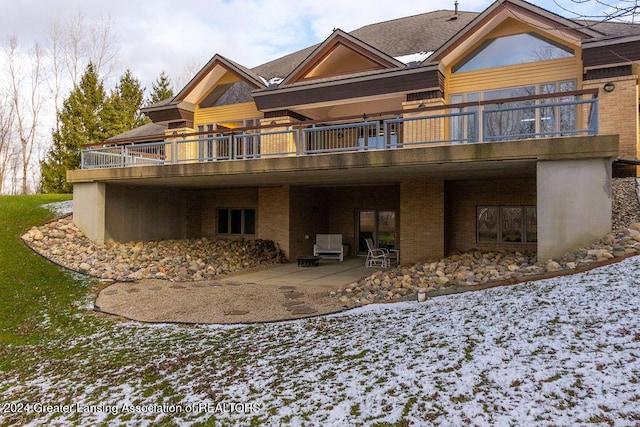 snow covered house with a patio