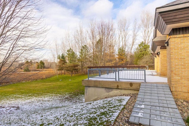 yard layered in snow featuring a wooden deck