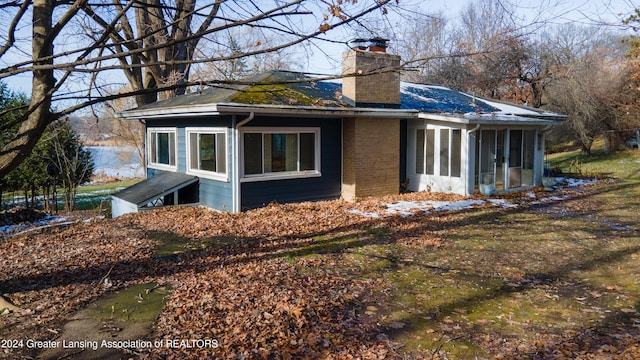 view of side of home with a sunroom