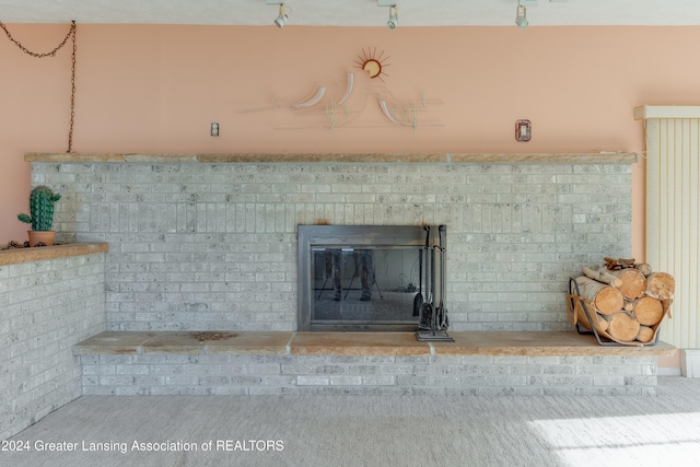 details featuring carpet flooring and a brick fireplace