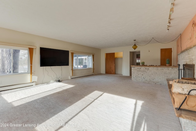 carpeted living room with rail lighting and a baseboard radiator