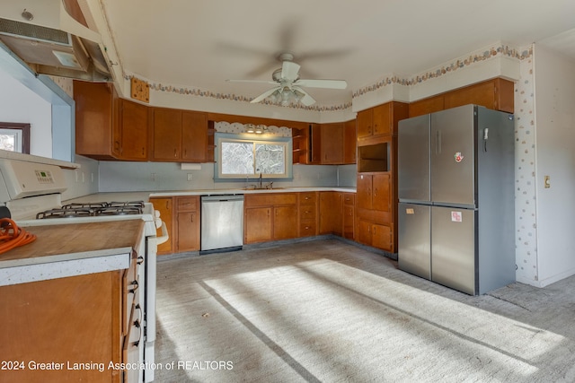 kitchen featuring light carpet, appliances with stainless steel finishes, ceiling fan, and sink