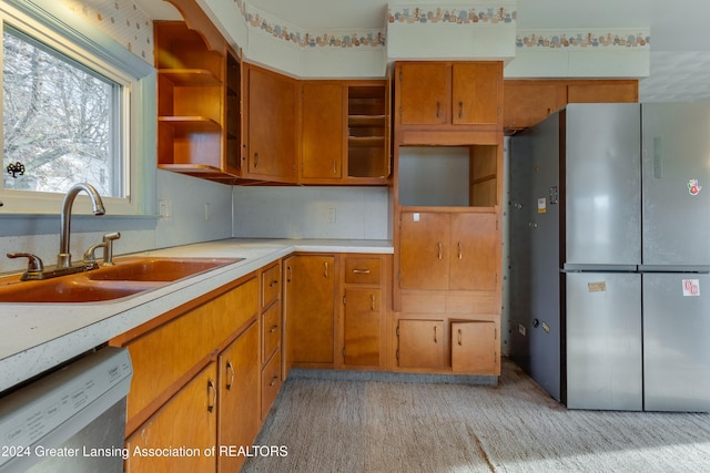 kitchen with dishwasher, sink, stainless steel refrigerator, and light carpet