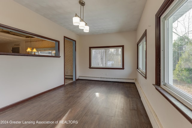 unfurnished room featuring a chandelier, a baseboard radiator, and dark hardwood / wood-style floors