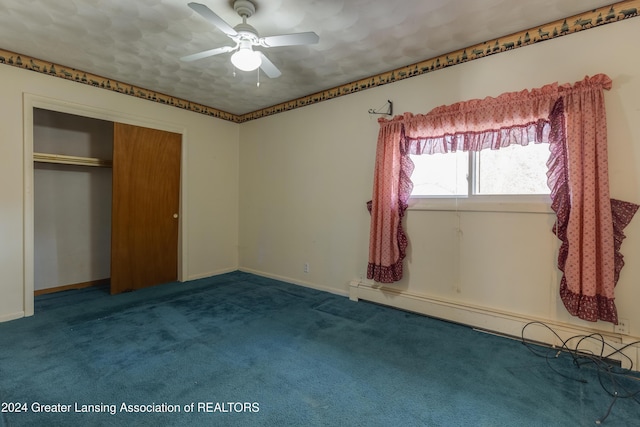 unfurnished bedroom with carpet, ceiling fan, baseboard heating, and a closet