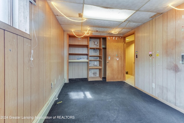 interior space with wood walls and carpet