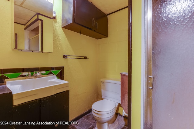 bathroom with tile patterned floors, vanity, and toilet