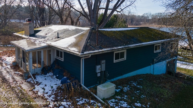 view of side of property featuring a sunroom