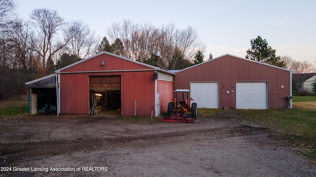 outdoor structure at dusk featuring a garage