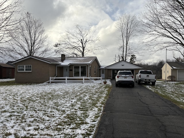 single story home with an outbuilding and a garage