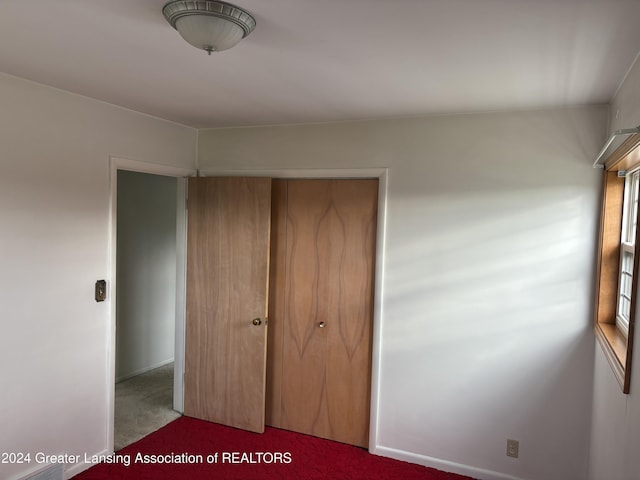 unfurnished bedroom with carpet floors and a closet