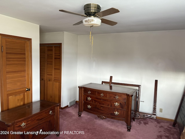 bedroom with ceiling fan and dark carpet