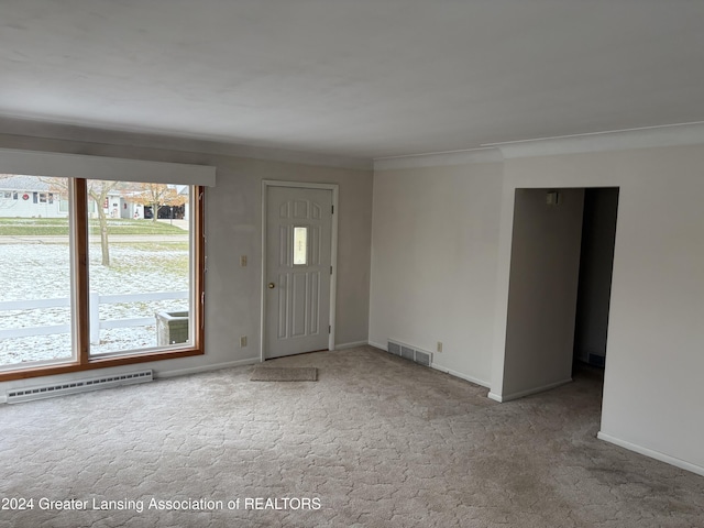 carpeted spare room featuring ornamental molding