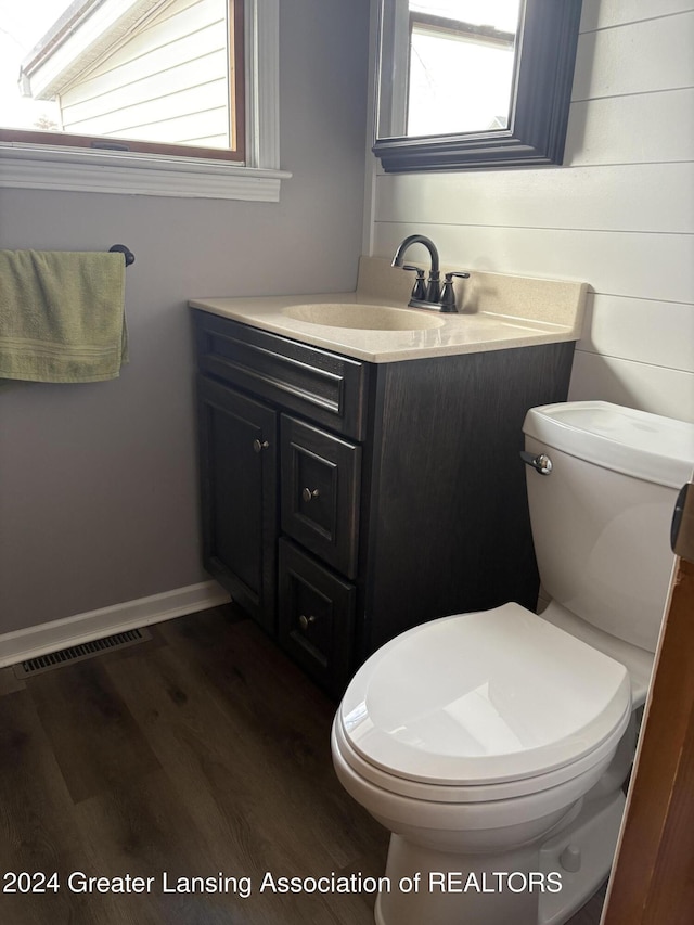 bathroom featuring hardwood / wood-style floors, vanity, and toilet