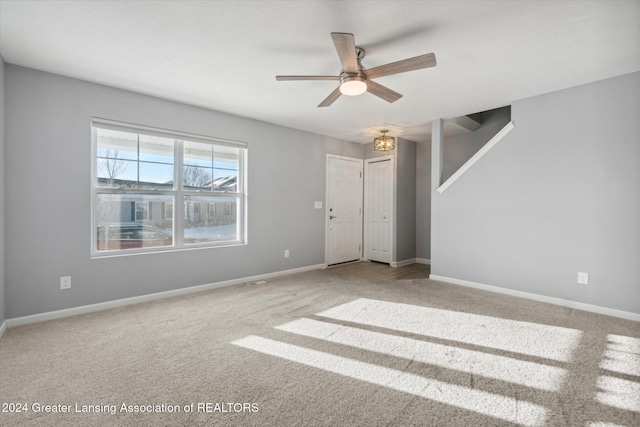 unfurnished room with carpet and ceiling fan