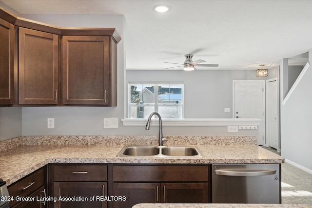 kitchen featuring ceiling fan, sink, stainless steel dishwasher, carpet floors, and dark brown cabinets