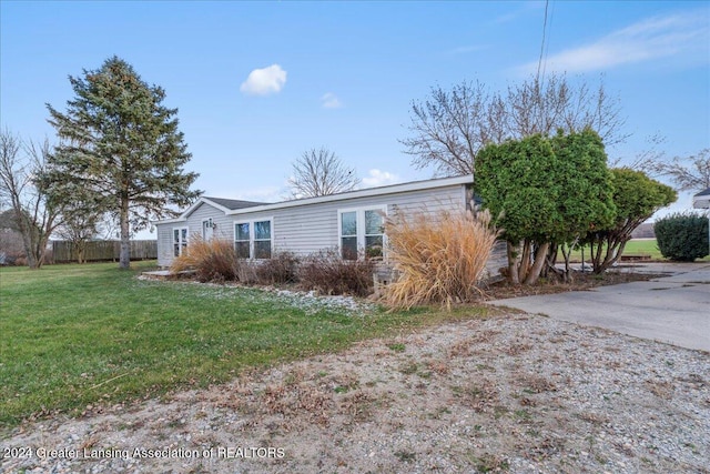 view of side of home featuring a yard