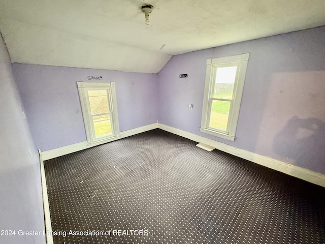 spare room featuring vaulted ceiling