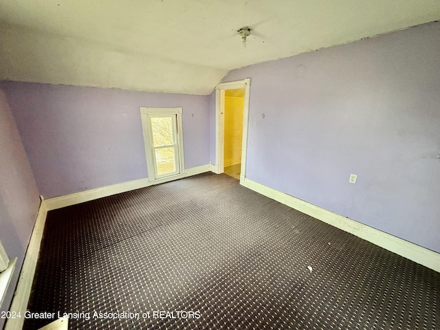 spare room featuring vaulted ceiling